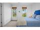 Bright bedroom with blue accents and leafy views at 2908 Old Drake Dr, Seabrook Island, SC 29455