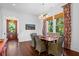 Bright dining room with wicker chairs, wood table, and hardwood floors at 2908 Old Drake Dr, Seabrook Island, SC 29455