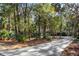 Long driveway leading to a two-story house nestled among trees at 2908 Old Drake Dr, Seabrook Island, SC 29455