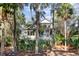 Two-story home with screened porch and lush landscaping at 2908 Old Drake Dr, Seabrook Island, SC 29455