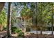 Two-story house with light green siding, a wraparound porch, and a staircase at 2908 Old Drake Dr, Seabrook Island, SC 29455