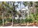 Two-story home with screened porch and lush landscaping at 2908 Old Drake Dr, Seabrook Island, SC 29455