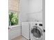 Bright laundry room with washer, dryer, and shelving at 2908 Old Drake Dr, Seabrook Island, SC 29455