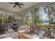 Relaxing screened porch with wooden furniture, overlooking a tranquil pond at 2908 Old Drake Dr, Seabrook Island, SC 29455