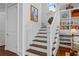 Elegant staircase with built-in shelving and hardwood floors at 2908 Old Drake Dr, Seabrook Island, SC 29455