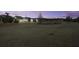 Evening view of community backyard with pond and homes at 304 Bloomington Way, Summerville, SC 29486