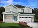 Two-story house with light teal siding, white trim, and a two-car garage at 322 Calm Water Way, Summerville, SC 29486