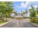 Inviting community entrance with manicured landscaping, palm trees, and well-maintained road at 355 Cooper River Dr, Mount Pleasant, SC 29464