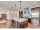 Well-lit kitchen featuring island, stainless steel appliances, and marble countertops and backsplash at 355 Cooper River Dr, Mount Pleasant, SC 29464