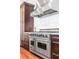 Stainless steel Viking range and hood featuring dark wood cabinets and marble backsplash at 355 Cooper River Dr, Mount Pleasant, SC 29464