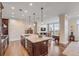 Stylish kitchen with an island with marble countertop, dark wood cabinets, and view of living area at 355 Cooper River Dr, Mount Pleasant, SC 29464