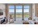 Comfortable living room featuring large windows showcasing scenic water and marsh views at 355 Cooper River Dr, Mount Pleasant, SC 29464