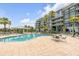 Beautiful outdoor pool area with lounge chairs and covered seating with tropical landscaping near the building at 355 Cooper River Dr, Mount Pleasant, SC 29464