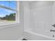 Bathroom with a tub, shower, and window offering natural light at 3725 Grange Cir, Summerville, SC 29486