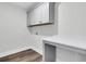 Laundry room with gray cabinets, a white countertop, and wood-look flooring at 3725 Grange Cir, Summerville, SC 29486