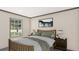 Relaxing bedroom featuring large window, wood furniture, and neutral walls at 380 Dike Rd, Bonneau, SC 29431