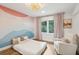 Cozy bedroom with accent wall and window seating at 3906 Waterway Blvd, Isle of Palms, SC 29451