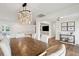 Open dining room with a rustic table and views to living room at 3906 Waterway Blvd, Isle of Palms, SC 29451
