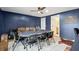 Game room with poker table, leather couch, and dark blue walls at 3906 Waterway Blvd, Isle of Palms, SC 29451