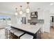 Modern kitchen with white cabinets and a large quartz island at 3906 Waterway Blvd, Isle of Palms, SC 29451