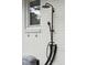 Modern black outdoor shower on white brick wall at 3906 Waterway Blvd, Isle of Palms, SC 29451