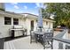 Outdoor patio with dining table, umbrella, and grill at 3906 Waterway Blvd, Isle of Palms, SC 29451