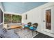 Screened porch features wicker chairs and a light blue ceiling at 3906 Waterway Blvd, Isle of Palms, SC 29451