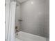 Bathroom with gray tile shower/tub combo, shelf, and gold fixtures at 391 Wappoo Trace Ln, Summerville, SC 29486