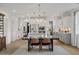 Open concept dining room with kitchen island and large chandelier at 391 Wappoo Trace Ln, Summerville, SC 29486