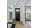 Light and airy foyer with a black front door and hardwood floors at 391 Wappoo Trace Ln, Summerville, SC 29486