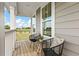 Inviting front porch with wooden deck and comfy seating at 391 Wappoo Trace Ln, Summerville, SC 29486