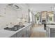 Modern kitchen with gas cooktop, white cabinets and gray lower cabinets at 391 Wappoo Trace Ln, Summerville, SC 29486