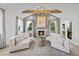 Elegant living room with a fireplace, vaulted ceiling and large windows at 391 Wappoo Trace Ln, Summerville, SC 29486