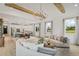 Open living room and kitchen with hardwood floors, modern chandelier, and large windows at 391 Wappoo Trace Ln, Summerville, SC 29486