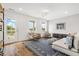 Bright living room with comfy seating, large windows, and hardwood floors at 391 Wappoo Trace Ln, Summerville, SC 29486