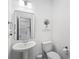Small powder room with a pedestal sink and a white toilet at 391 Wappoo Trace Ln, Summerville, SC 29486