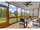 Relaxing screened porch with seating area and ceiling fan at 391 Wappoo Trace Ln, Summerville, SC 29486