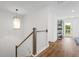 Upstairs hall with a staircase, balcony access, and built-in shelving at 391 Wappoo Trace Ln, Summerville, SC 29486