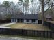 House with black fence, landscaping, and driveway at 402 Citadel St, Ladson, SC 29456