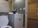 Clean bathroom with white vanity, black fixtures, and grey wainscoting at 402 Citadel St, Ladson, SC 29456
