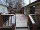 Large wooden deck with black railings and stairs leading to the backyard at 402 Citadel St, Ladson, SC 29456