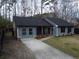 Newly renovated home featuring gray siding, black shutters, and landscaping at 402 Citadel St, Ladson, SC 29456