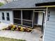 Newly painted house with screened porch, landscaping, and black fence at 402 Citadel St, Ladson, SC 29456