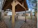 Wooden pergola with dining area and bar seating over a gravel base in backyard at 402 Citadel St, Ladson, SC 29456