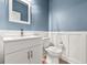 Modern bathroom with white vanity, toilet, and blue walls at 4041 Oxeye Loop, Johns Island, SC 29455
