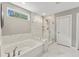 Elegant bathroom with soaking tub, glass shower, and marble tile at 4041 Oxeye Loop, Johns Island, SC 29455