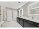 Luxurious bathroom with double vanity, marble tile, and frameless shower at 4041 Oxeye Loop, Johns Island, SC 29455