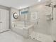 Spa-like bathroom with soaking tub, marble tile, and glass shower enclosure at 4041 Oxeye Loop, Johns Island, SC 29455