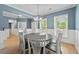 Bright dining room features a round table with six chairs and hardwood floors at 4041 Oxeye Loop, Johns Island, SC 29455