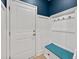 Inviting entryway with bench, coat hooks, and stylish blue accent wall at 4041 Oxeye Loop, Johns Island, SC 29455